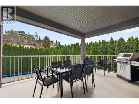 Private covered deck offering a comfortable outdoor space for morning coffee, summer dinners, or relaxing with family and friends. at 2512 Selkirk Drive, Dilworth Mountain, Kelowna