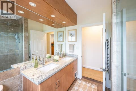 4-piece main bath with dual vanities and tiled shower at 860 Fairview Road, Oliver
