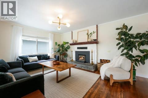 Living room with wood-burning stove at 860 Fairview Road, Oliver