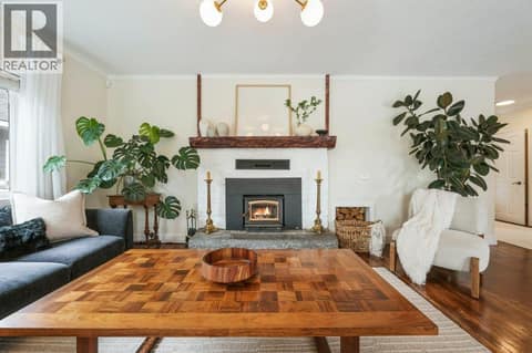 Living room with wood-burning stove at 860 Fairview Road, Oliver