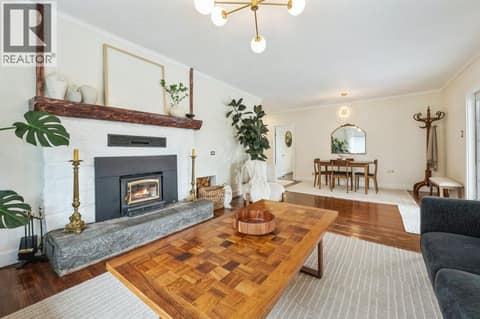 Living room with wood-burning stove at 860 Fairview Road, Oliver