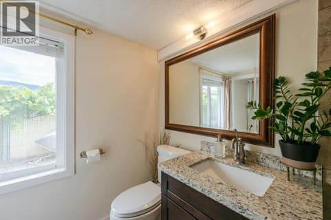 Primary bedroom ensuite - granite counters at 860 Fairview Road, Oliver