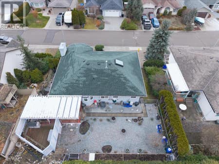 Looking down into backyard and the covered patio at 4205 Wellington Drive, East Hill, Vernon