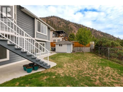 Fenced backyard with access to upper deck plus a storage shed at 2280 Shannon Hills Drive, Shannon Lake, West Kelowna