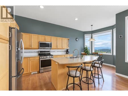 Kitchen with island and stainless steel appliance (gas stove) at 2280 Shannon Hills Drive, Shannon Lake, West Kelowna