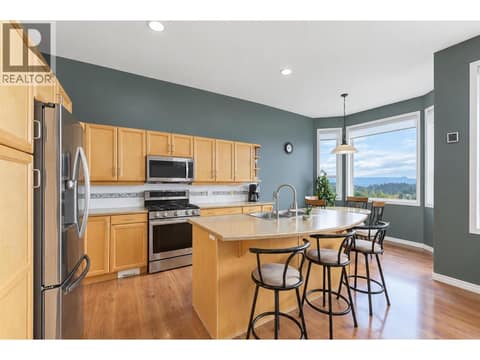 Kitchen with island and stainless steel appliance (gas stove) at 2280 Shannon Hills Drive, Shannon Lake, West Kelowna