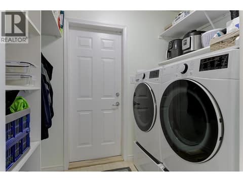 Laundry with access to the double garage at 2280 Shannon Hills Drive, Shannon Lake, West Kelowna