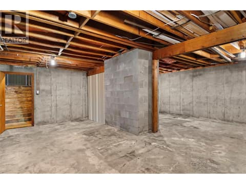 Downstairs - VIRTUALLY CLEANED unfinished room with direct access to attached garage. at 1669 Hiob Road, Revelstoke
