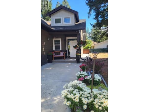 Front entrance when the flowers are in bloom at 259 Grouse Avenue, Okanagan North, Vernon