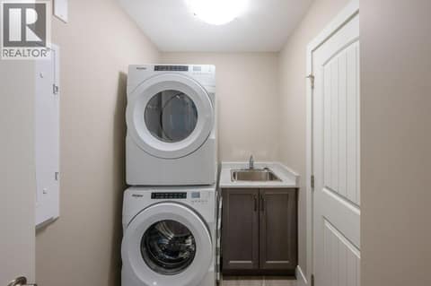 Main floor laundry with sink at 2450 Radio Tower Road Unit# 70, Oliver Rural