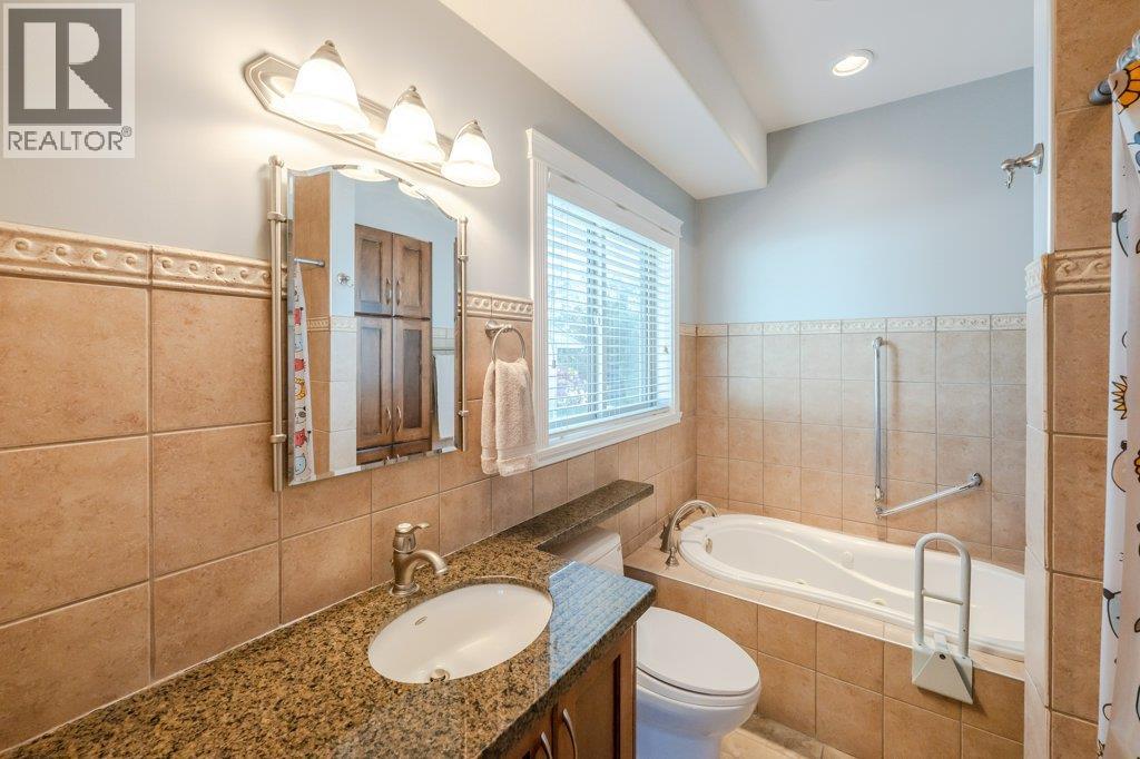 4-piece ensuite with walk-in shower & soaker tub at 1124 Fairview Road, Oliver