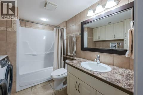 Basement 4-piece bath & laundry at 1124 Fairview Road, Oliver