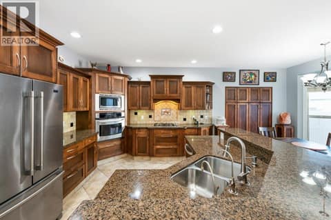 Kitchen - granite counters, built-in oven, gas cooktop at 1124 Fairview Road, Oliver
