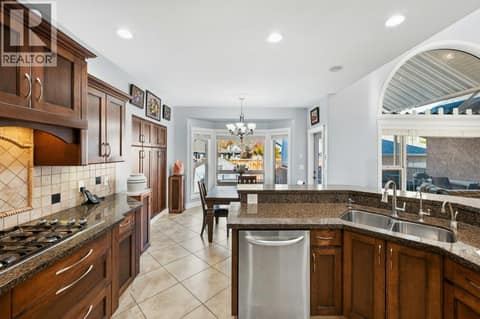 Kitchen - granite counters, built-in oven, gas cooktop at 1124 Fairview Road, Oliver