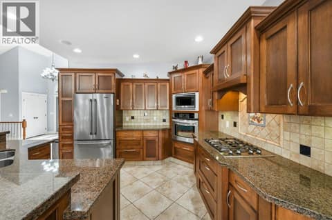 Kitchen - granite counters, built-in oven, gas cooktop at 1124 Fairview Road, Oliver