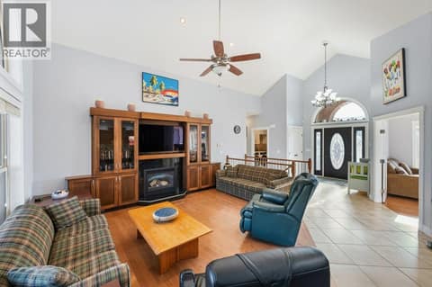 Living room, gas fireplace, vaulted ceiling at 1124 Fairview Road, Oliver