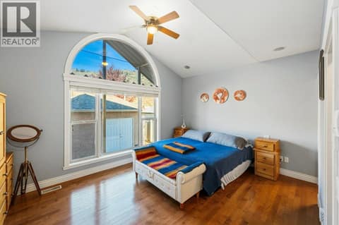 Primary bedroom, vaulted ceiling, walk-in closet, ensuite at 1124 Fairview Road, Oliver