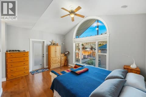 Primary bedroom, vaulted ceiling, walk-in closet, ensuite at 1124 Fairview Road, Oliver